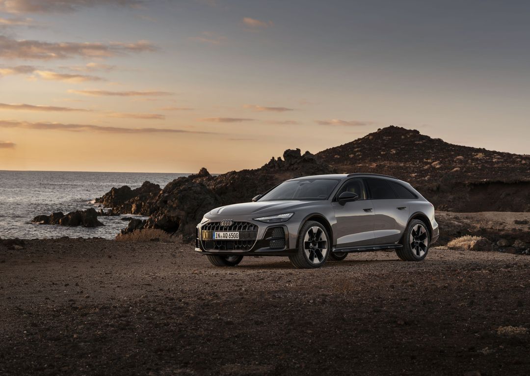 Audi A6 allroad C9 — ujęcie 3/4 z przodu, podobna kompozycja nadmorska przy zachodzie słońca, kadr nieznacznie odmienny