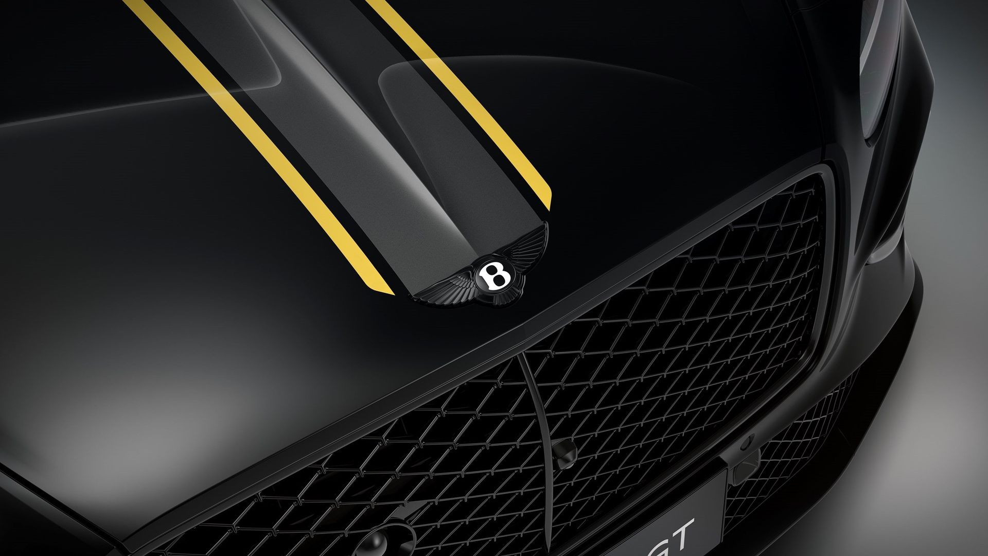 Bentley Mulliner — zbliżenie na maskę z żółtymi pasami i logo Bentley, czarne nadwozie