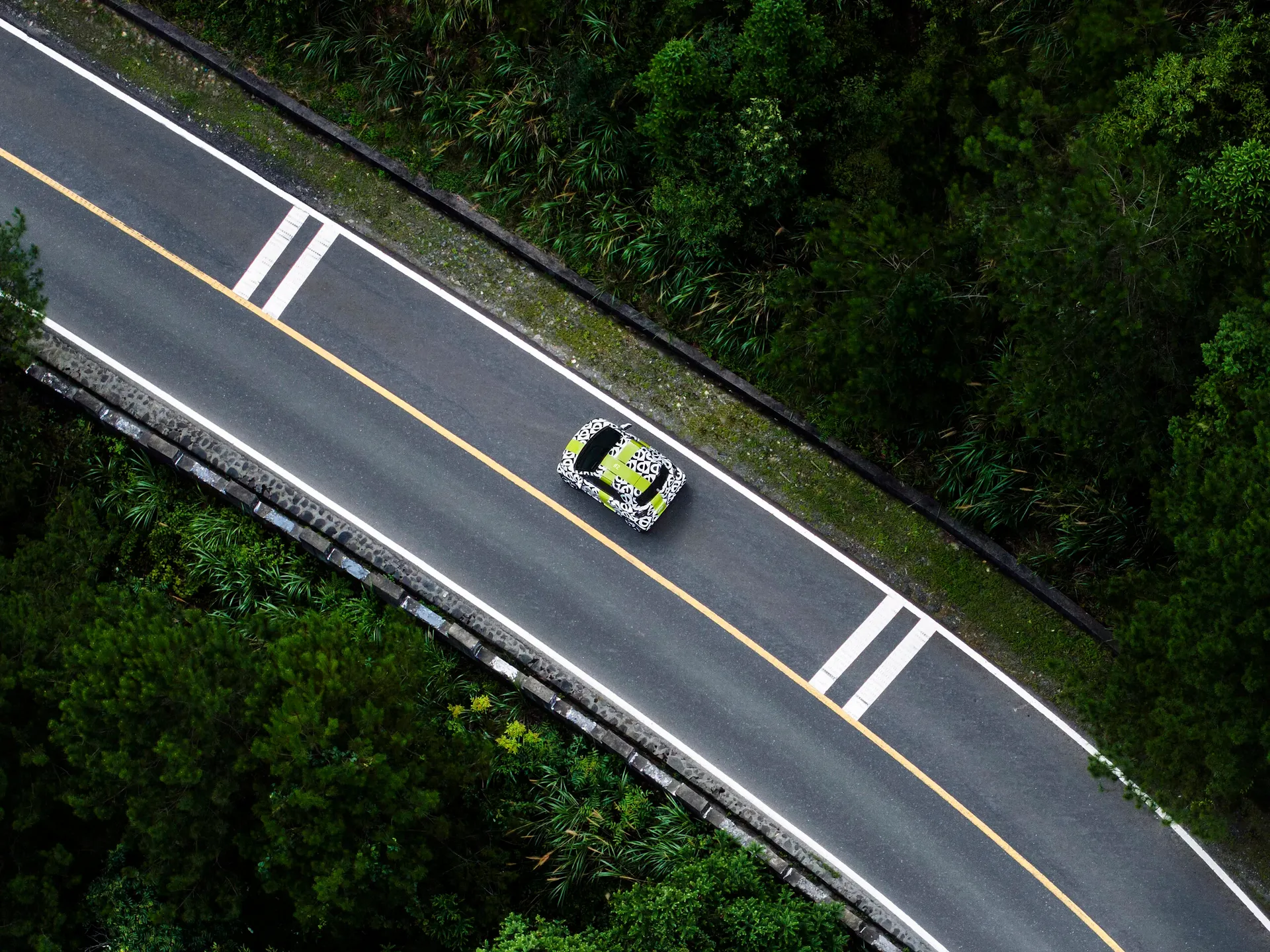 smart – zakamuflowany prototyp na leśnej drodze, ujęcie z lotu ptaka